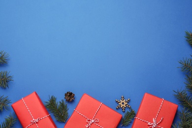 Flat lay composition with Christmas gifts on blue background, space for text. Boxing day