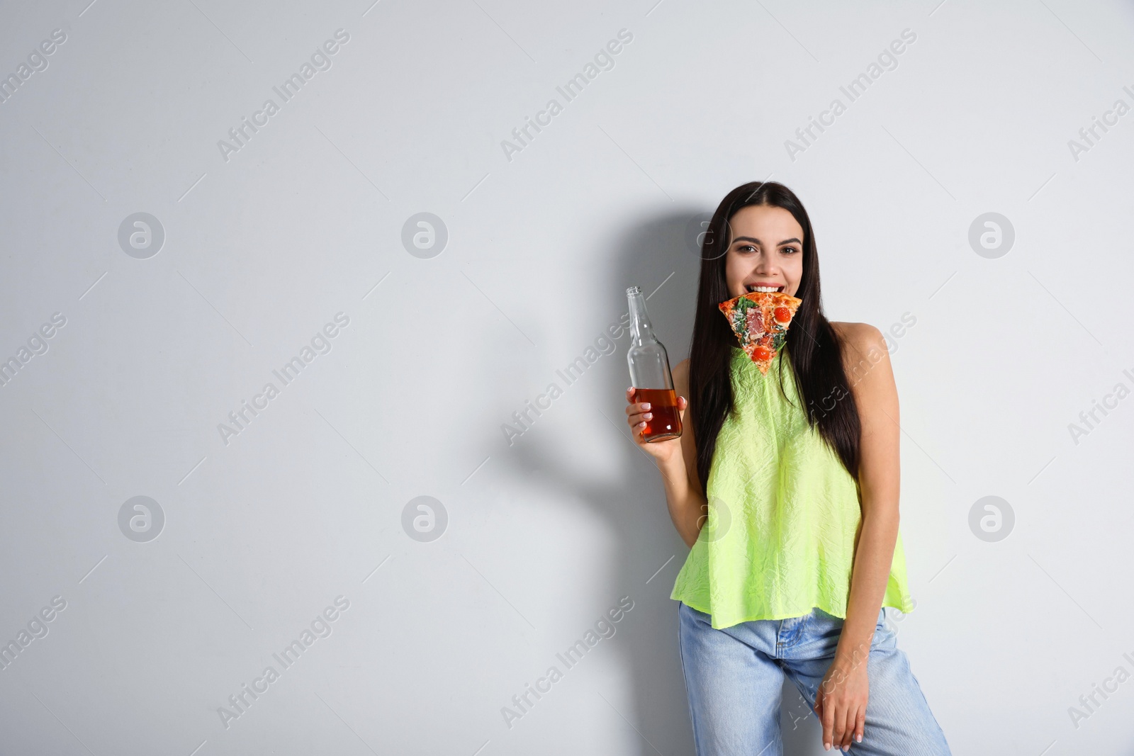 Photo of Happy woman with pizza and beer on white background, space for text