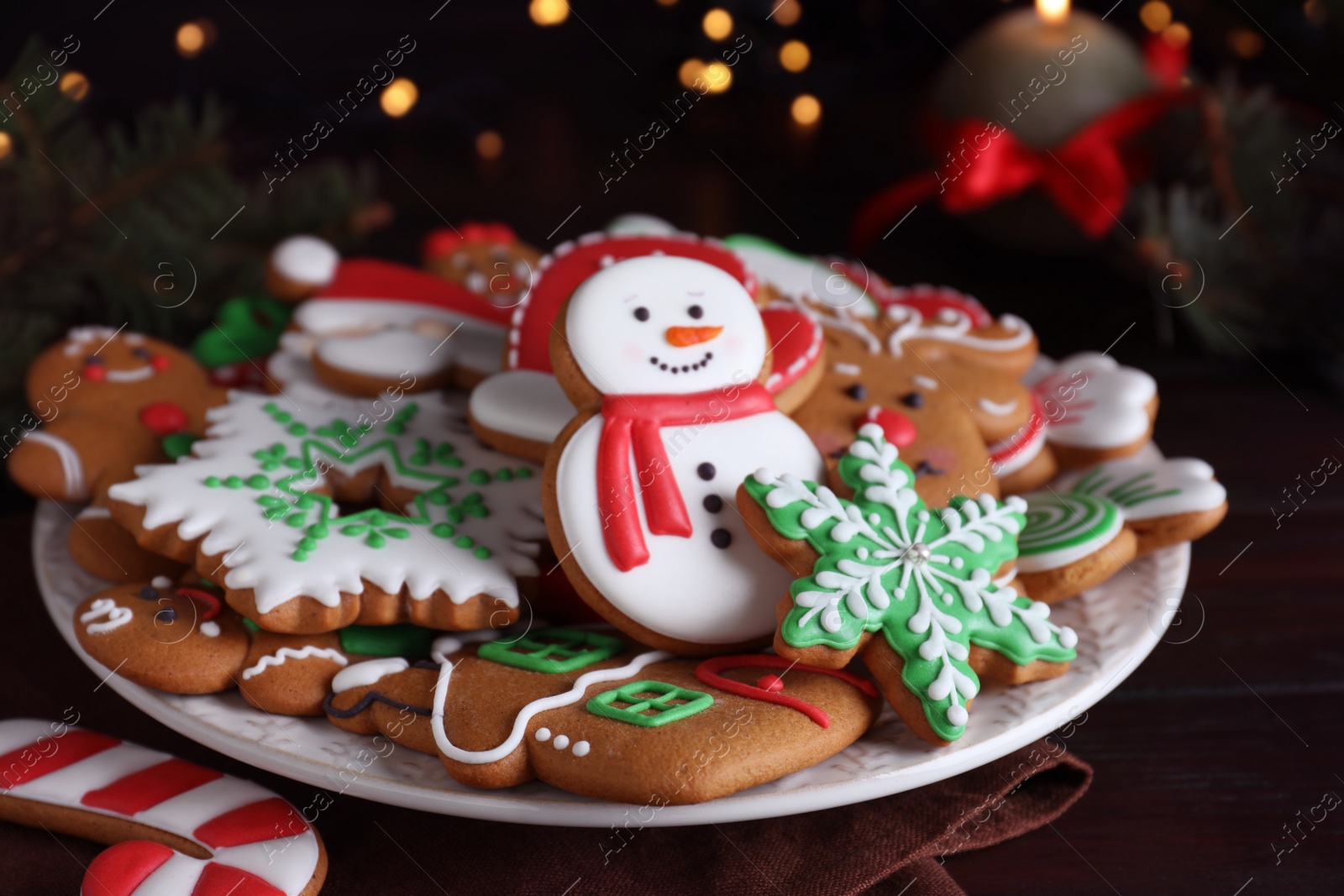 Photo of Delicious gingerbread Christmas cookies on wooden table, closeup