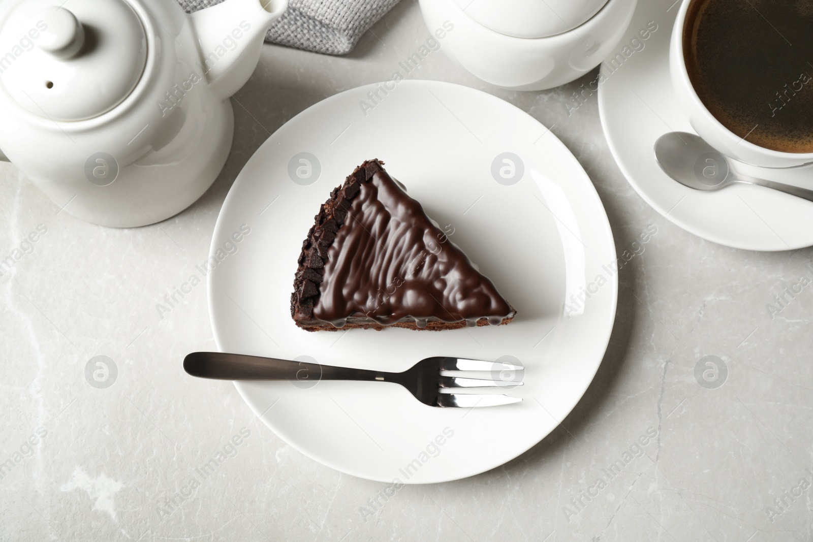 Photo of Tasty chocolate cake served on grey marble table, flat lay