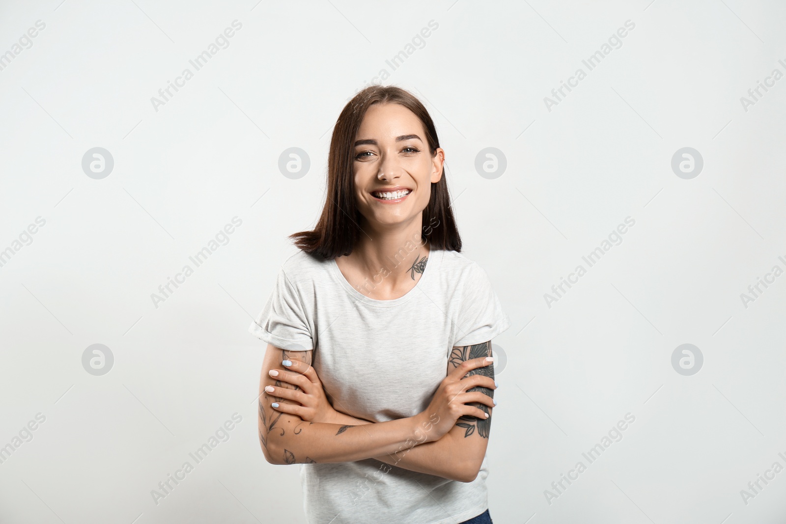 Photo of Portrait of pretty young woman with gorgeous chestnut hair and charming smile on light background