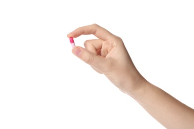 Photo of Woman holding color pill on white background, closeup