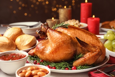 Photo of Traditional festive dinner with delicious roasted turkey served on table