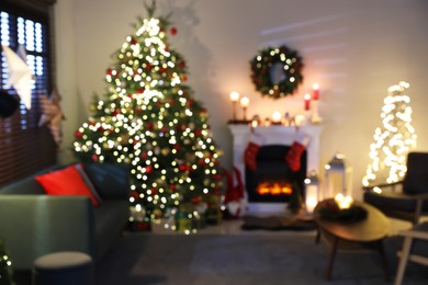 Photo of Blurred view of decorated room with Christmas tree and fireplace