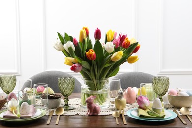 Festive table setting with beautiful flowers. Easter celebration