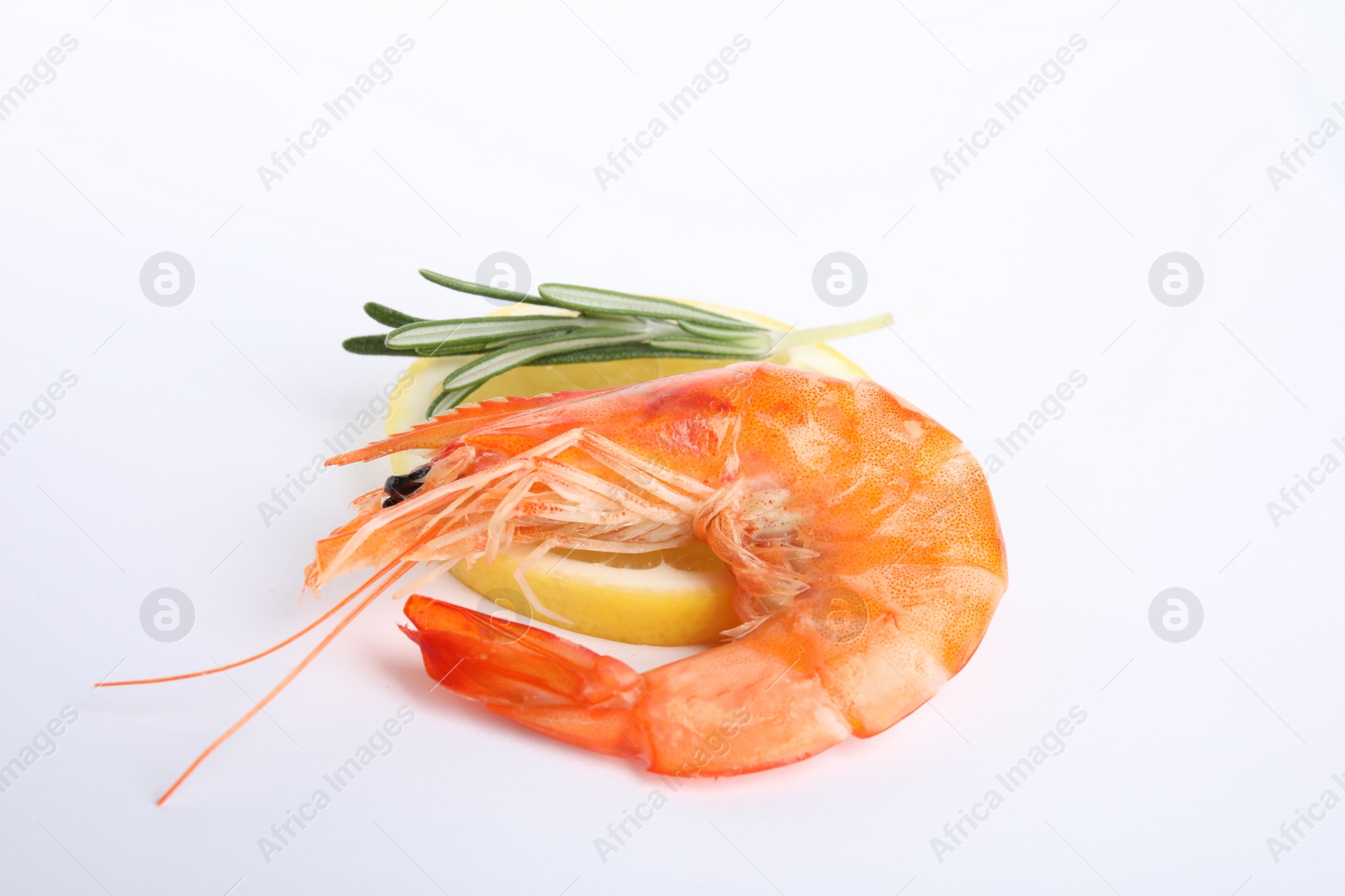 Photo of Delicious cooked shrimp, lemon and rosemary isolated on white