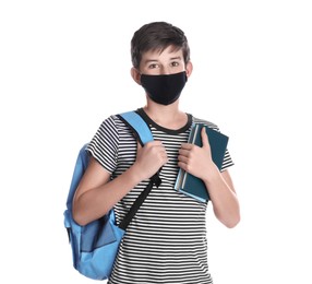 Boy wearing protective mask with backpack and books on white background. Child safety