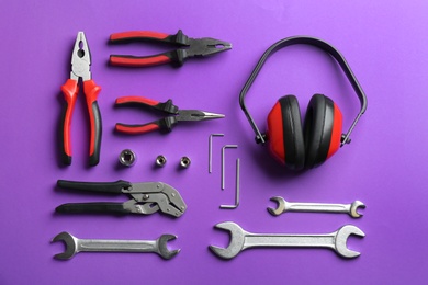 Photo of Flat lay composition with different construction tools on color background