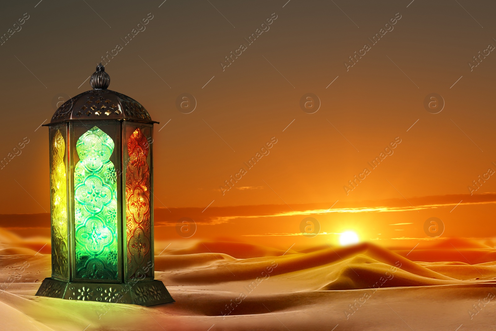 Image of Beautiful Arabic lantern on sand at sunset, space for text