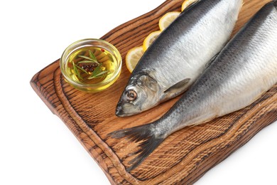 Photo of Wooden board with salted herrings, slices of lemon and oil on white background, closeup