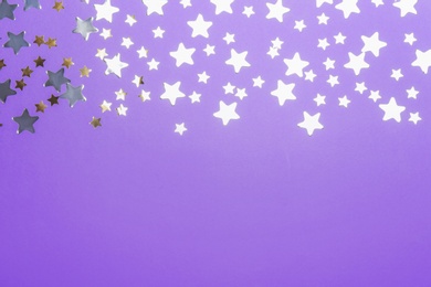 Photo of Confetti stars with space for text on violet background, top view. Christmas celebration