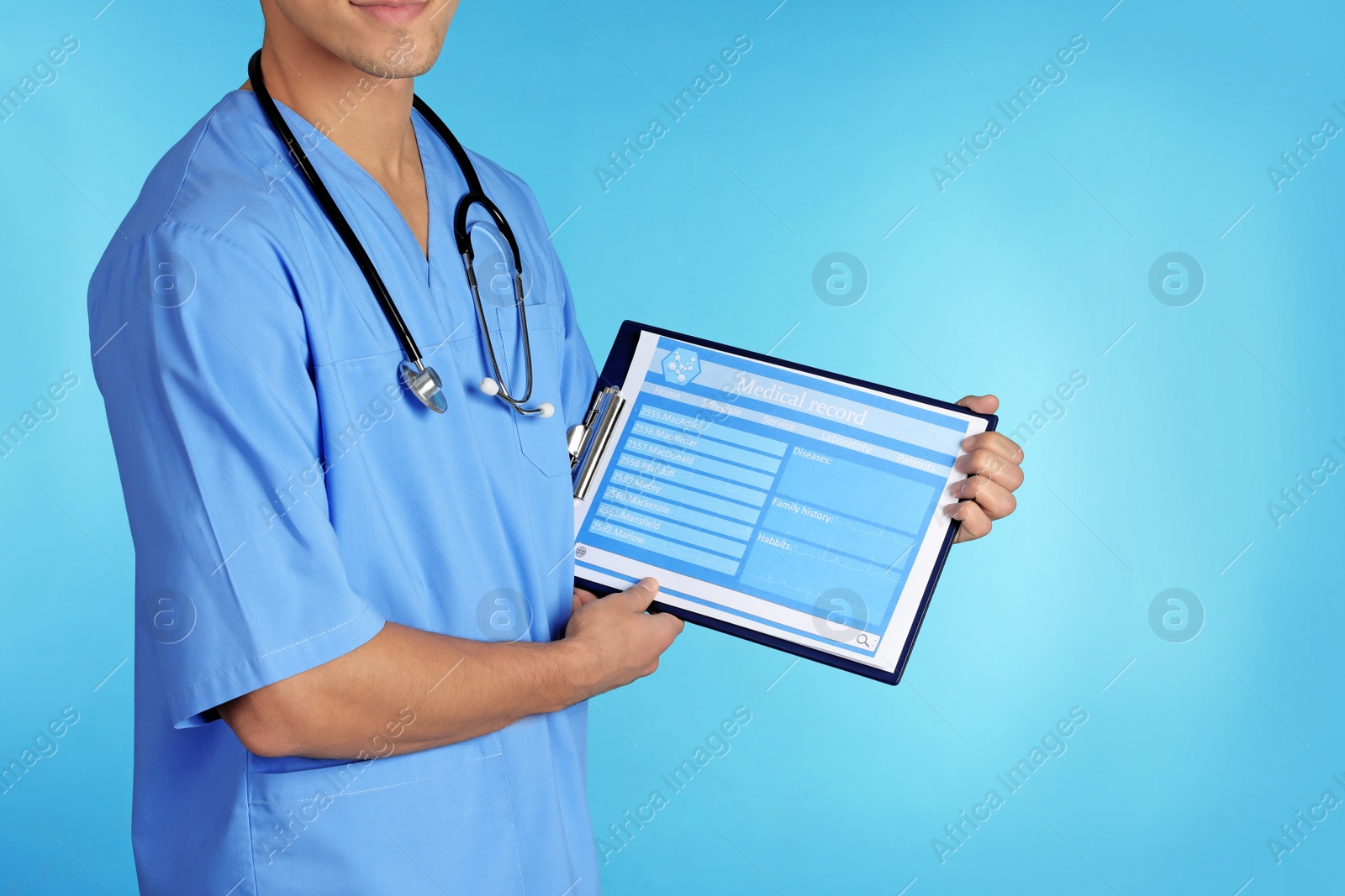 Photo of Male doctor holding stethoscope and clipboard with record form on color background, closeup. Medical objects