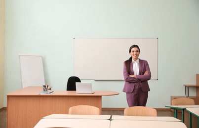 Photo of Portrait of female teacher in modern classroom