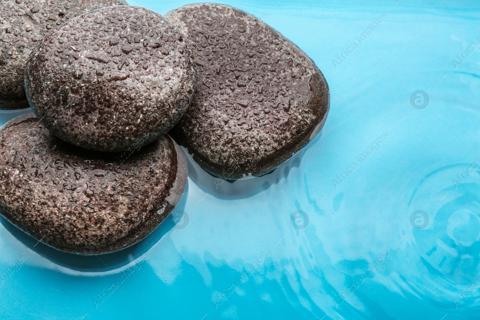 Photo of Stones in water, closeup view. Zen lifestyle