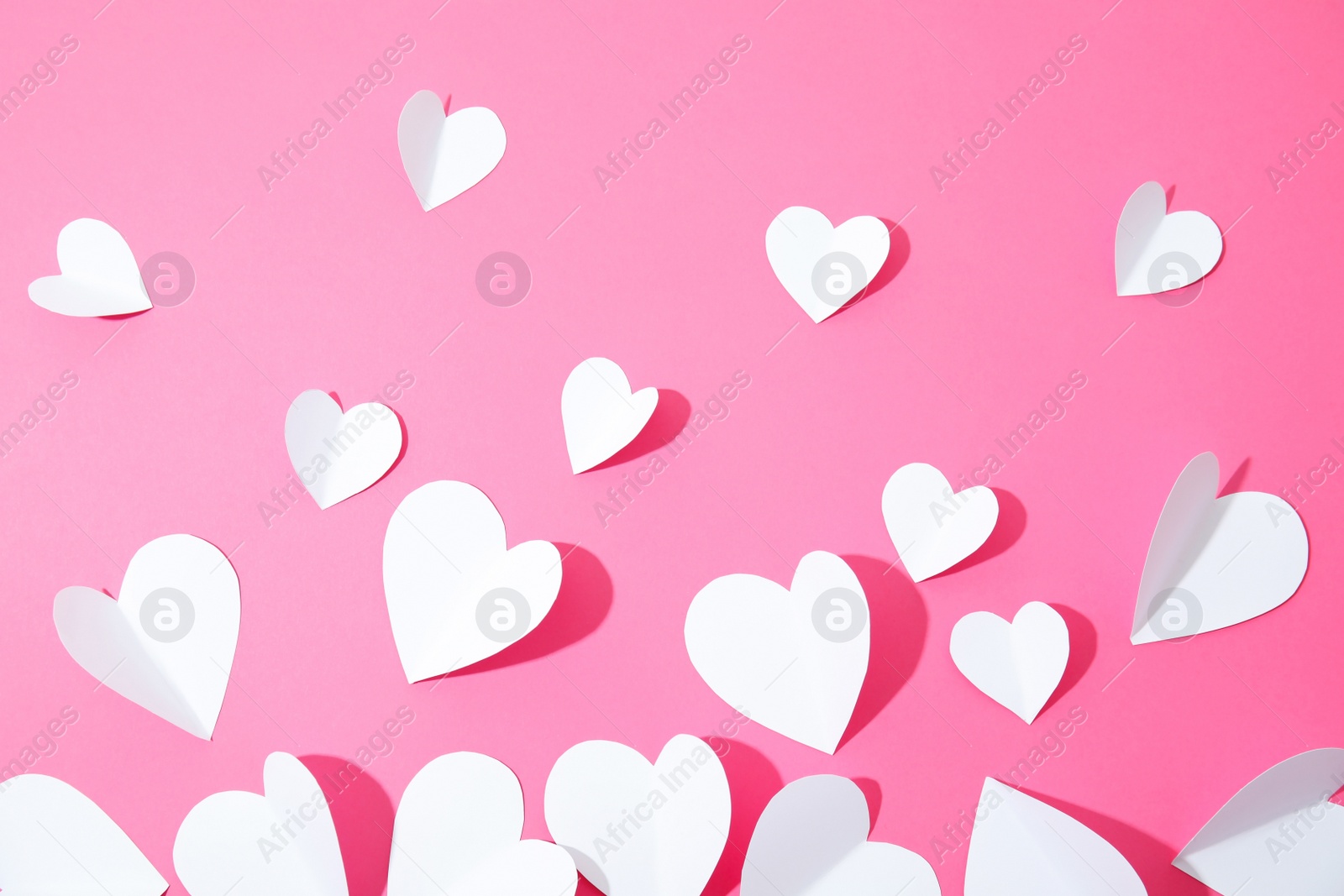 Photo of Small paper hearts on color background, top view