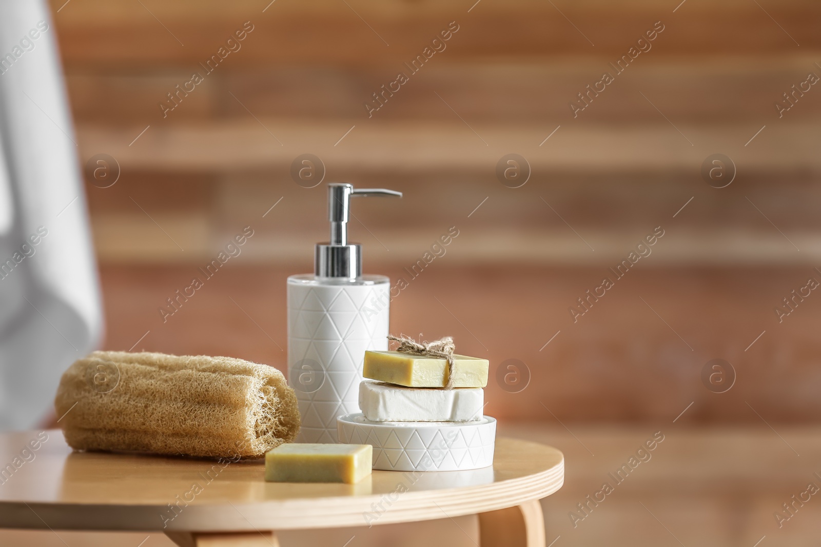 Photo of Composition with soap and toiletries on table against blurred background. Space for text