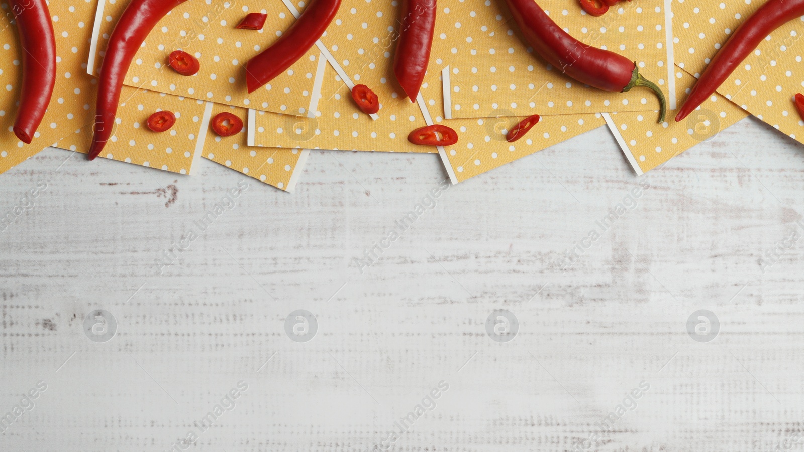 Photo of Pepper plasters and chili on white wooden table, flat lay. Space for text