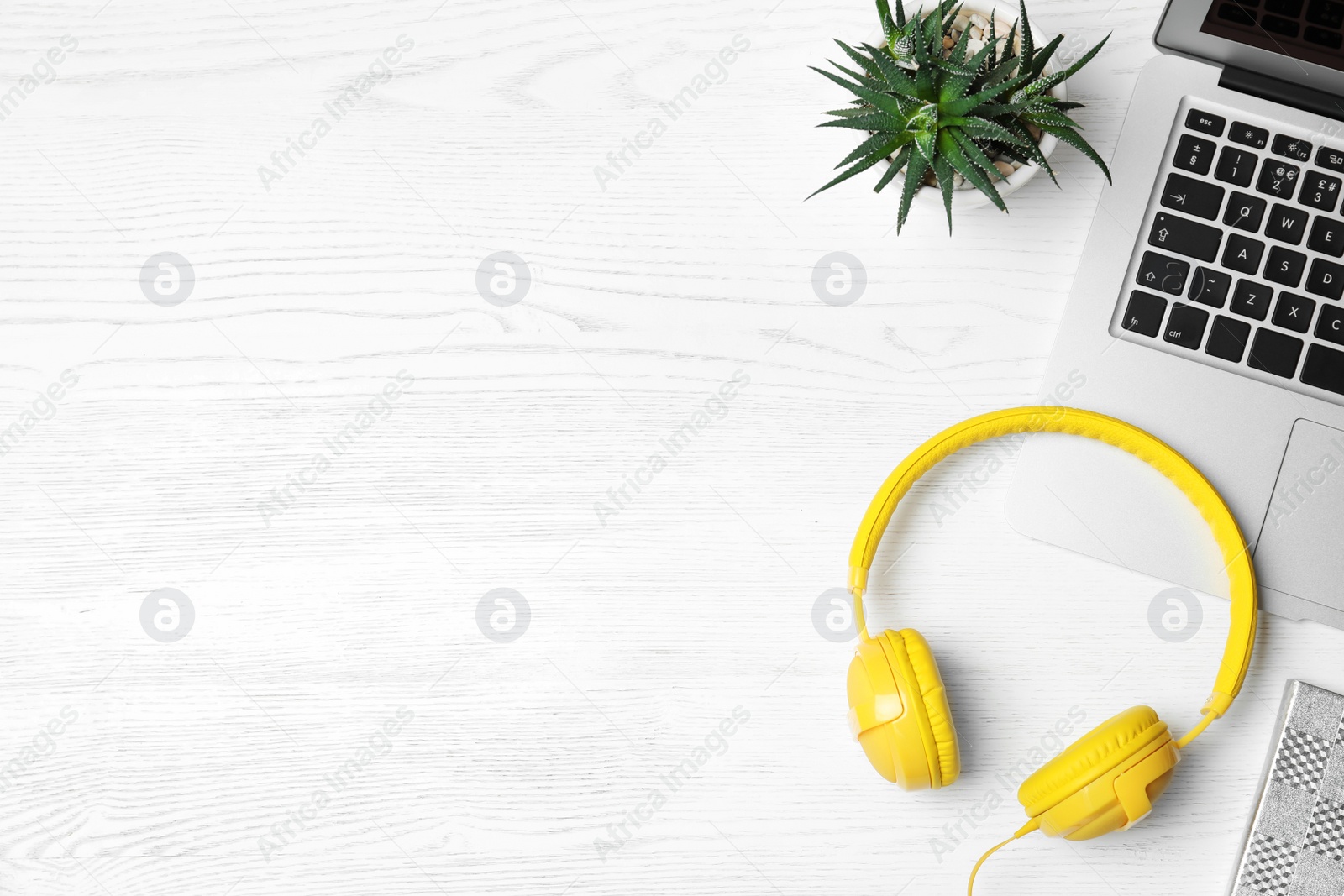 Photo of Flat lay composition with headphones, laptop and space for text on white wooden background