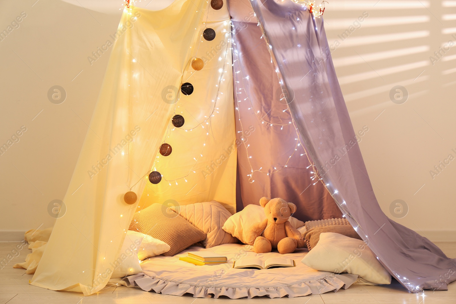 Photo of Modern children's room interior with play tent