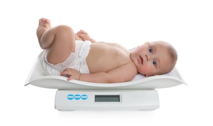 Photo of Cute little baby lying on scales against white background