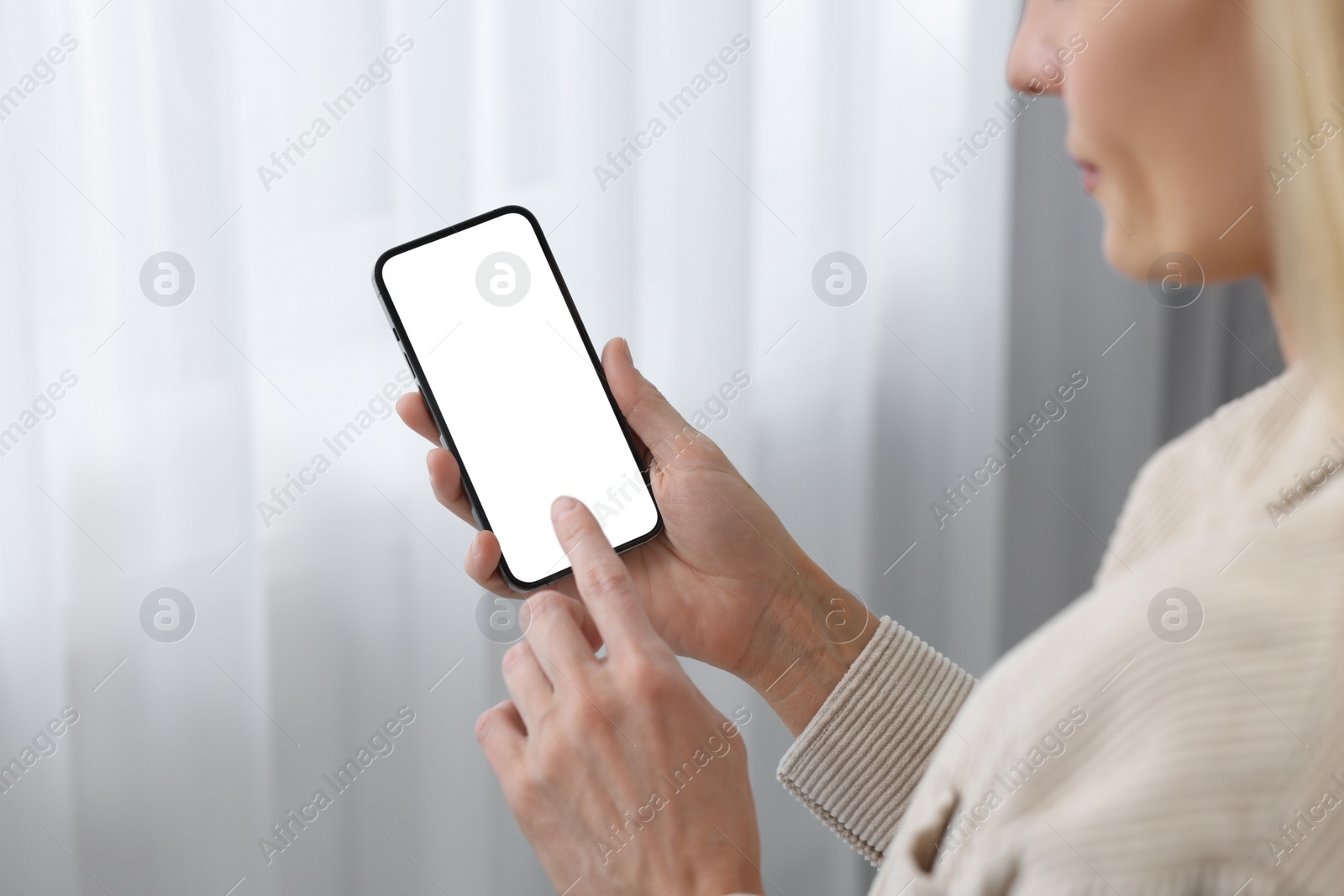 Photo of Woman using smartphone at home, closeup. Space for text