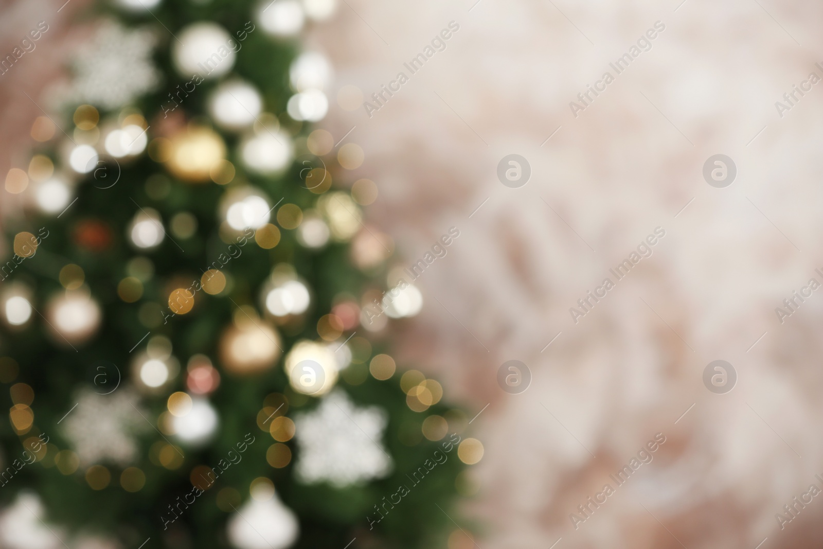 Photo of Beautiful Christmas tree with lights against brown background, blurred view. Space for text