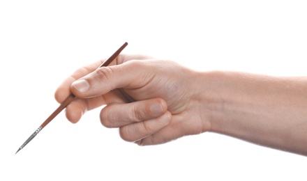 Man holding paint brush on white background, closeup