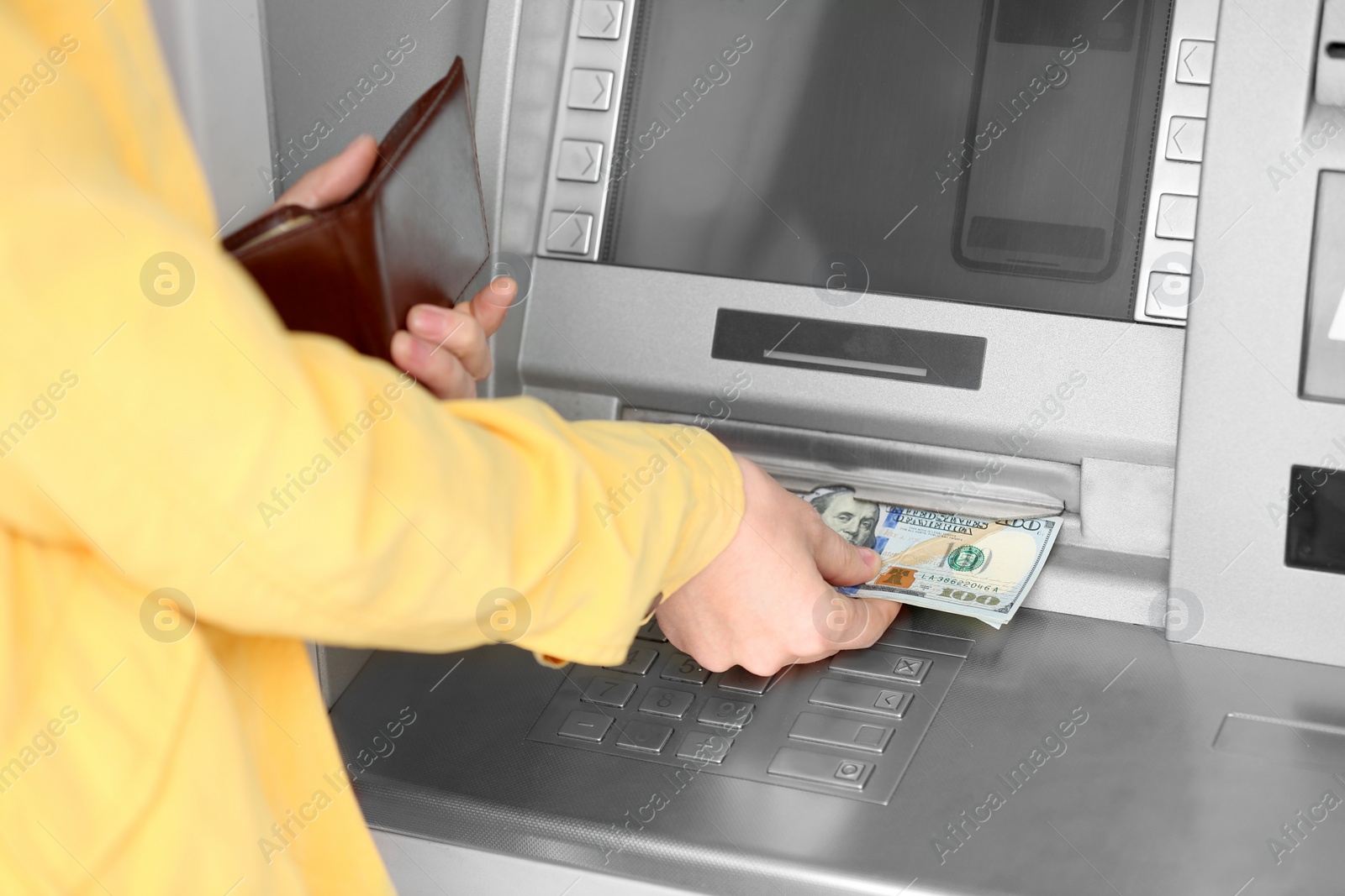 Photo of Woman taking money from cash machine outdoors, closeup