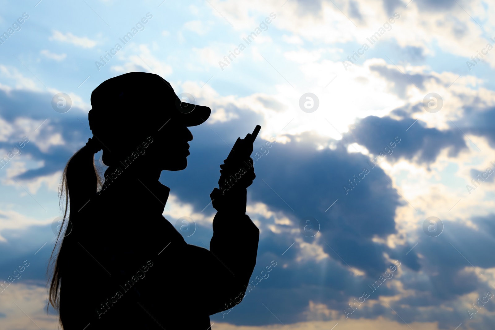 Photo of Female soldier with portable radio transmitter outdoors. Military service