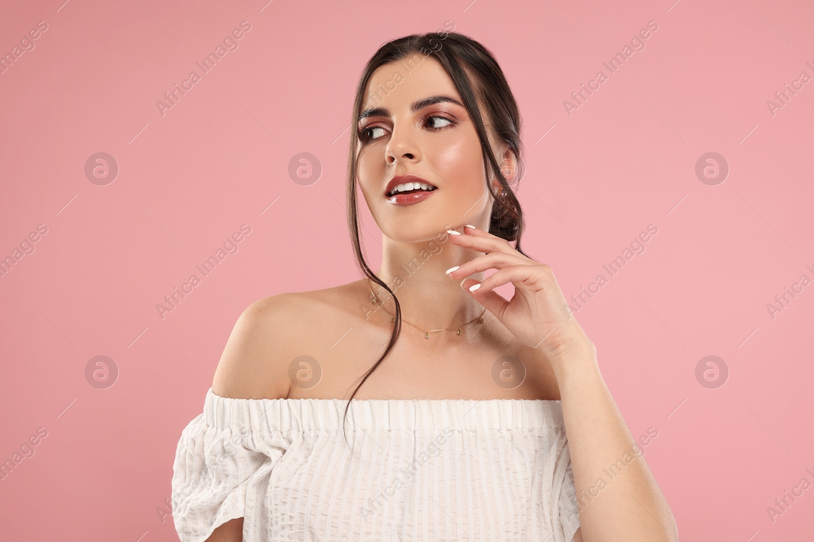 Photo of Beautiful woman with elegant jewelry on pink background