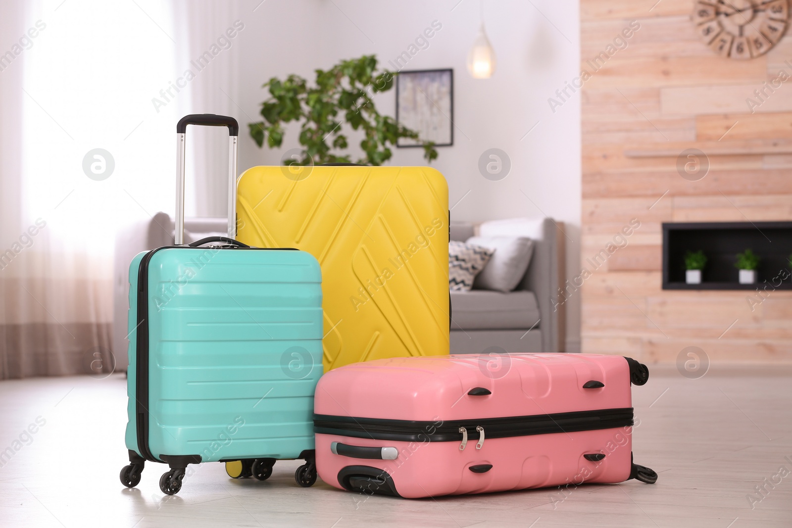 Photo of Colorful suitcases packed for journey in living room