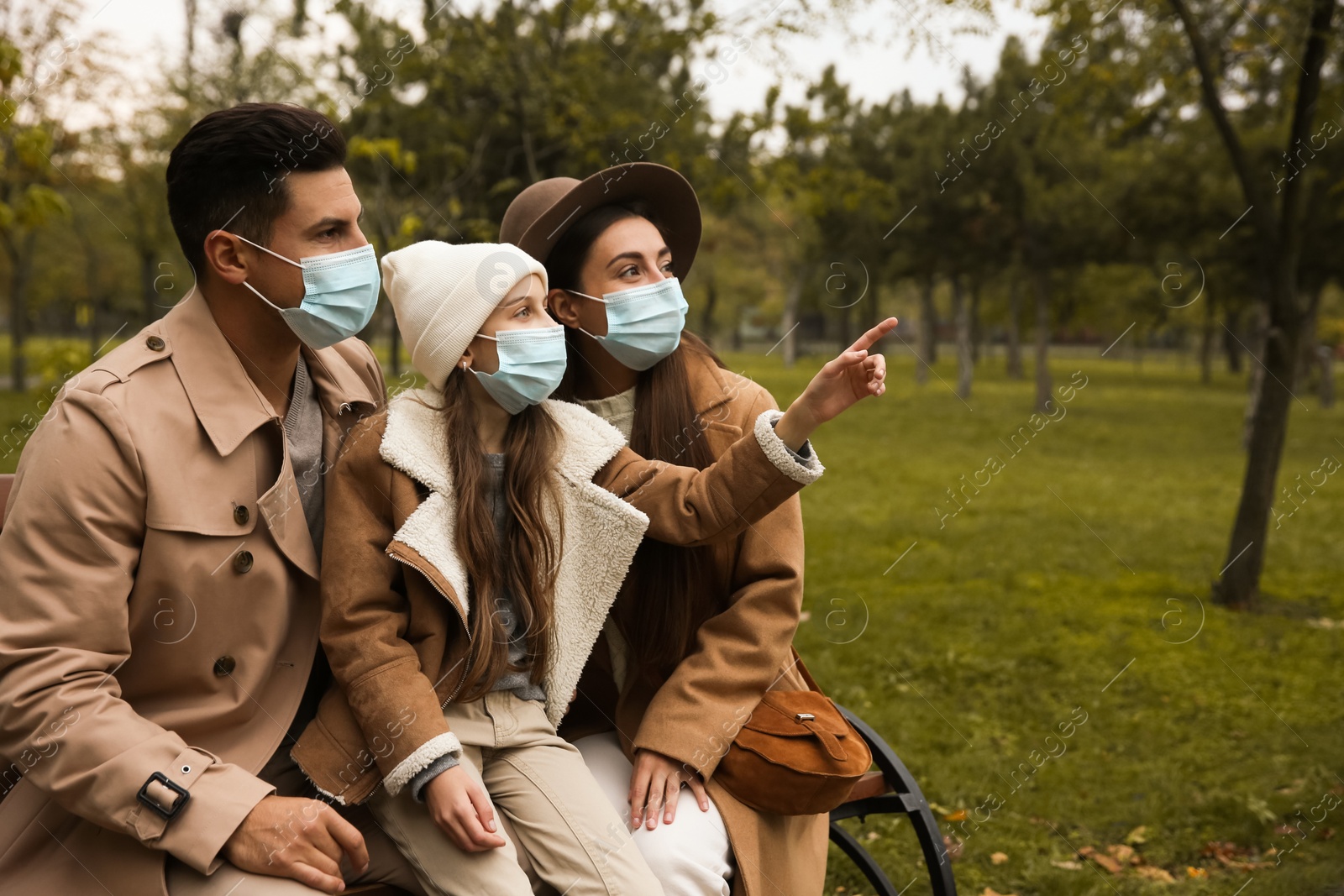 Photo of Lovely family spending time together in park during coronavirus pandemic