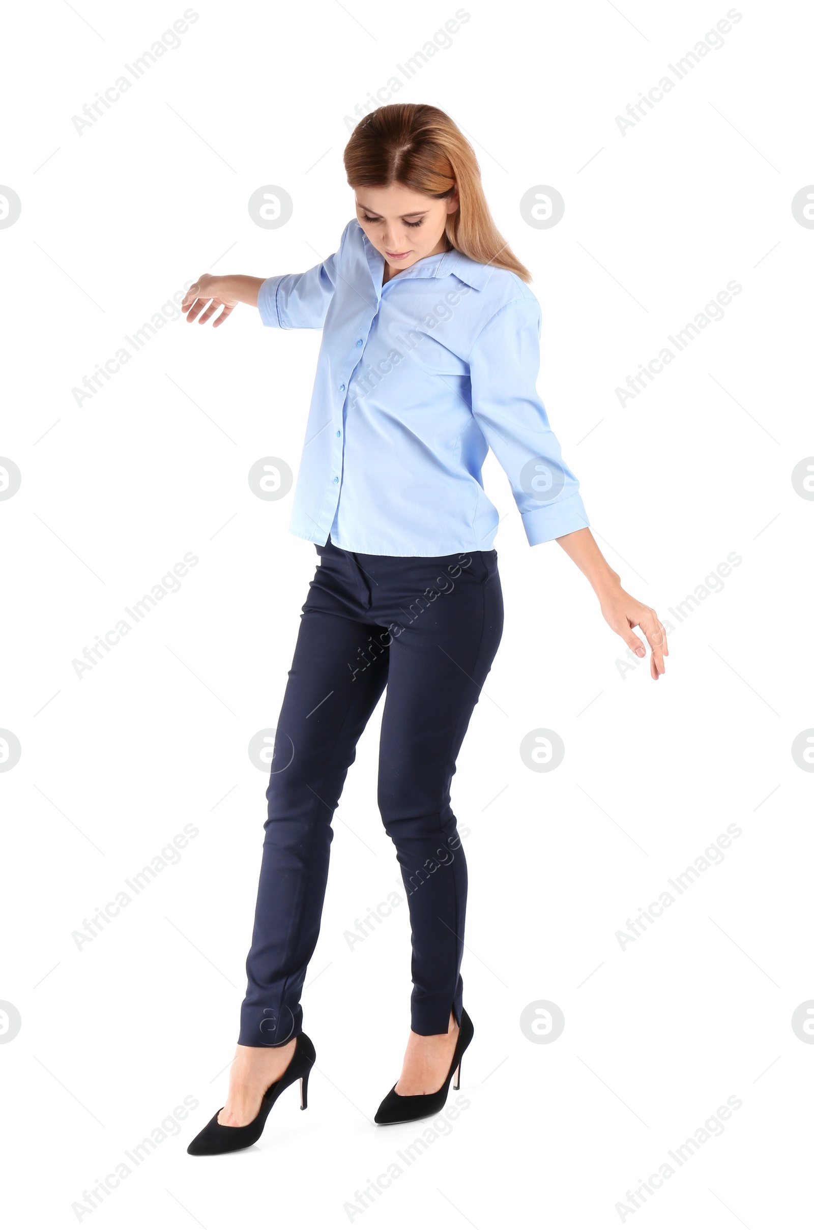 Photo of Full length portrait of businesswoman balancing on white background