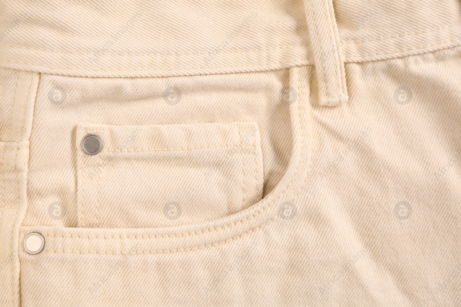 Photo of Beige jeans with inset pocket as background, closeup