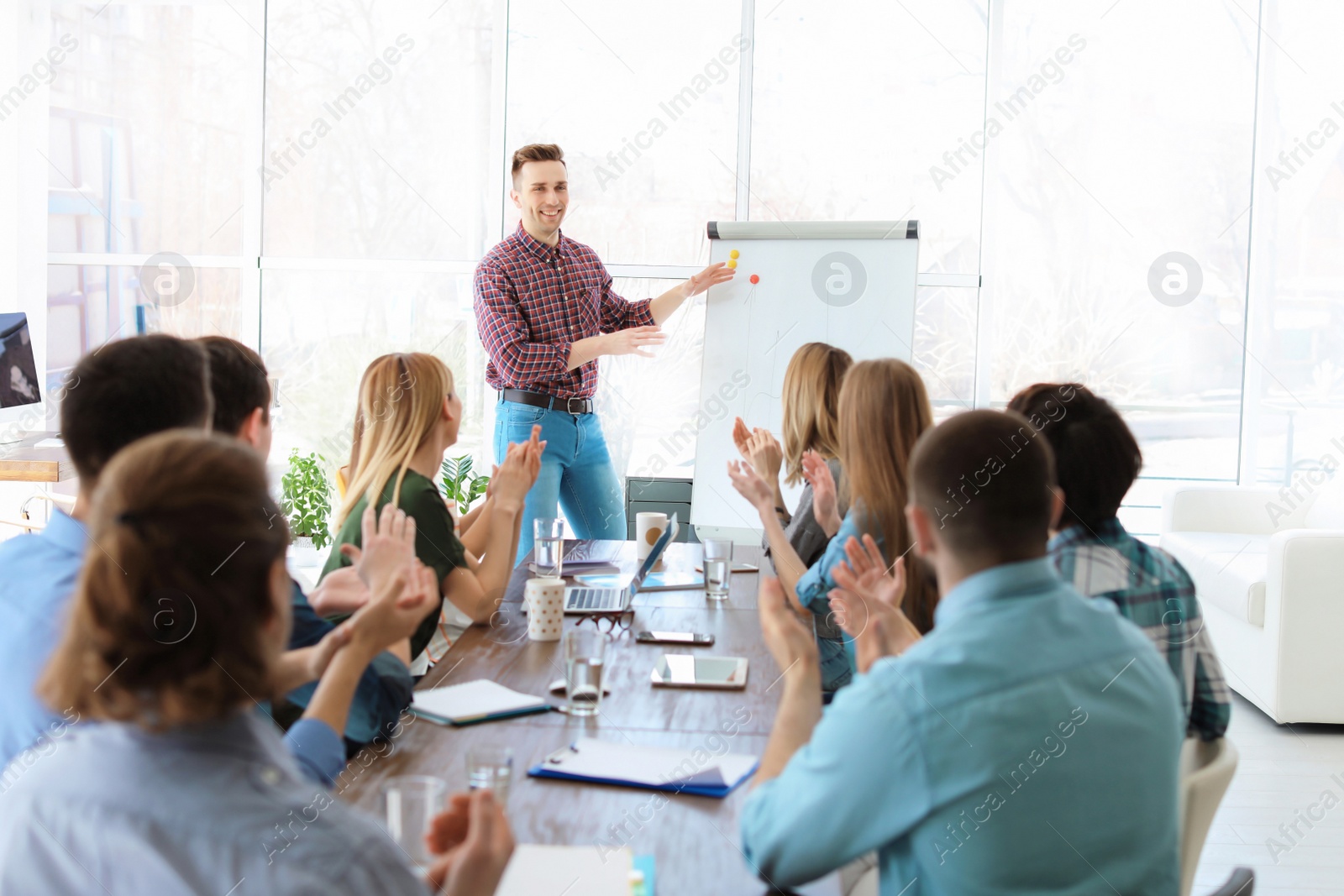 Photo of Male business trainer giving lecture in office