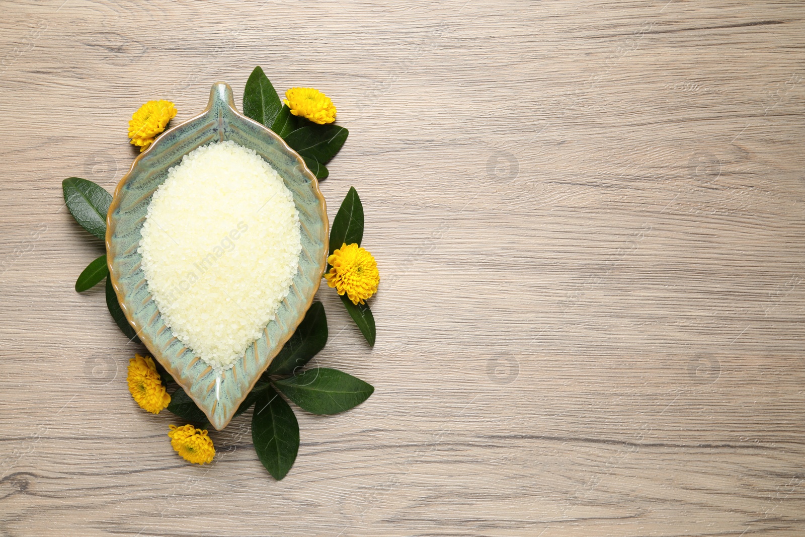 Photo of Flat lay composition with natural sea salt on wooden table. Space for text