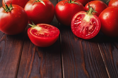 Fresh ripe red tomatoes on wooden table