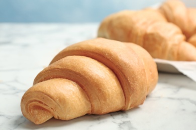 Photo of Tasty croissant on table, closeup