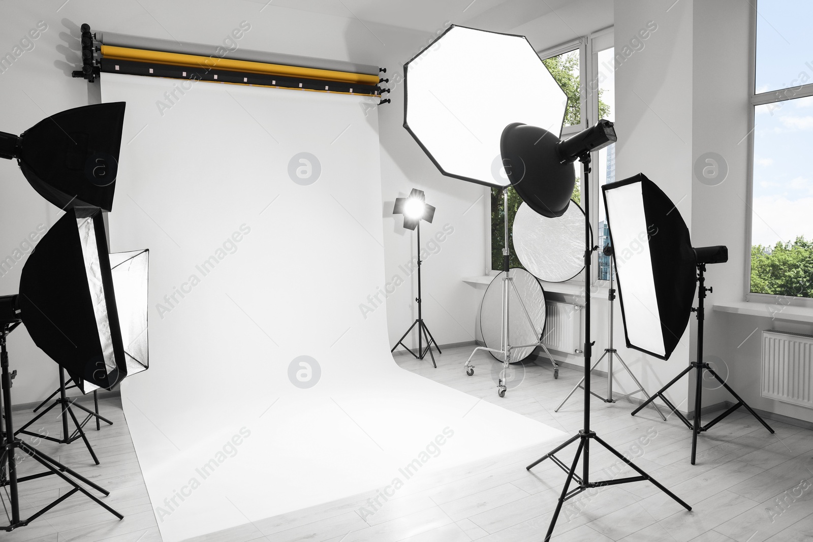 Photo of Interior of modern photo studio with professional lighting equipment