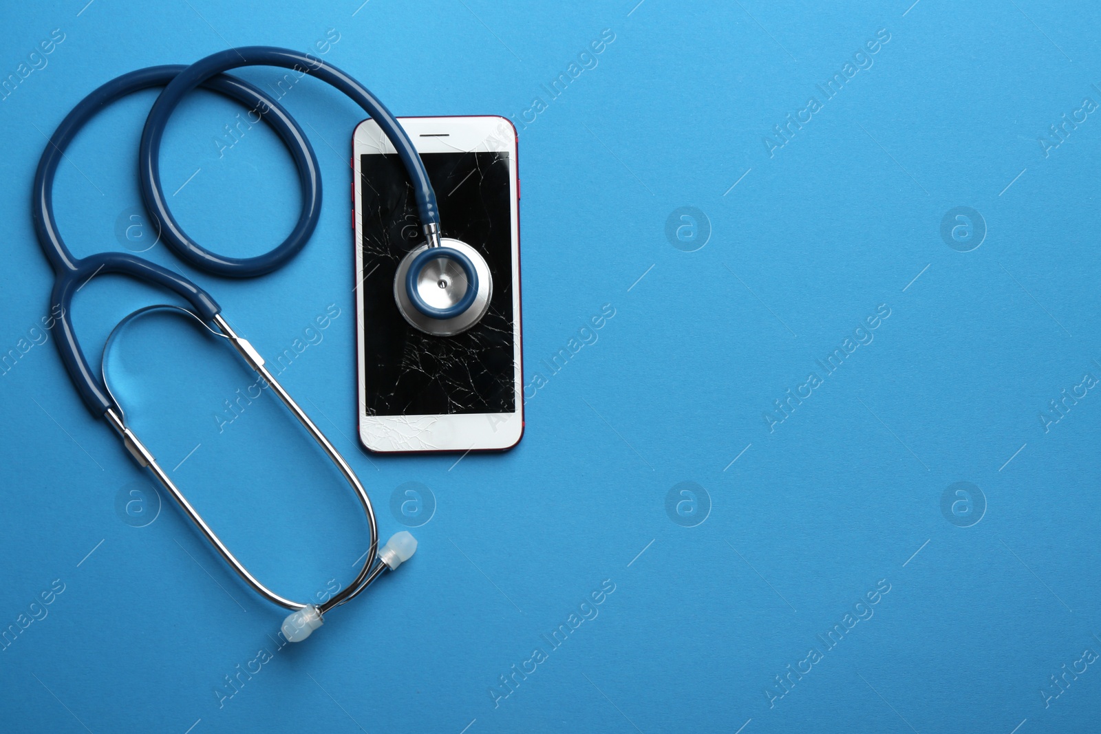 Photo of Modern smartphone with broken display, stethoscope and space for text on color background, flat lay. Device repair service