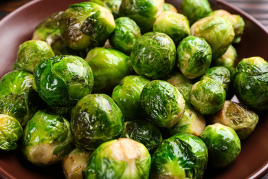 Delicious roasted Brussels sprouts on plate, closeup