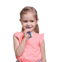 Photo of Birthday celebration. Cute little girl with blower on white background