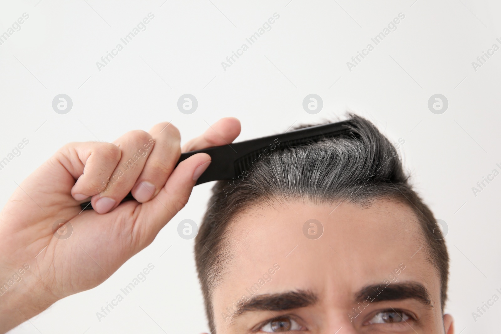 Image of Young man with grey hair on white background, closeup