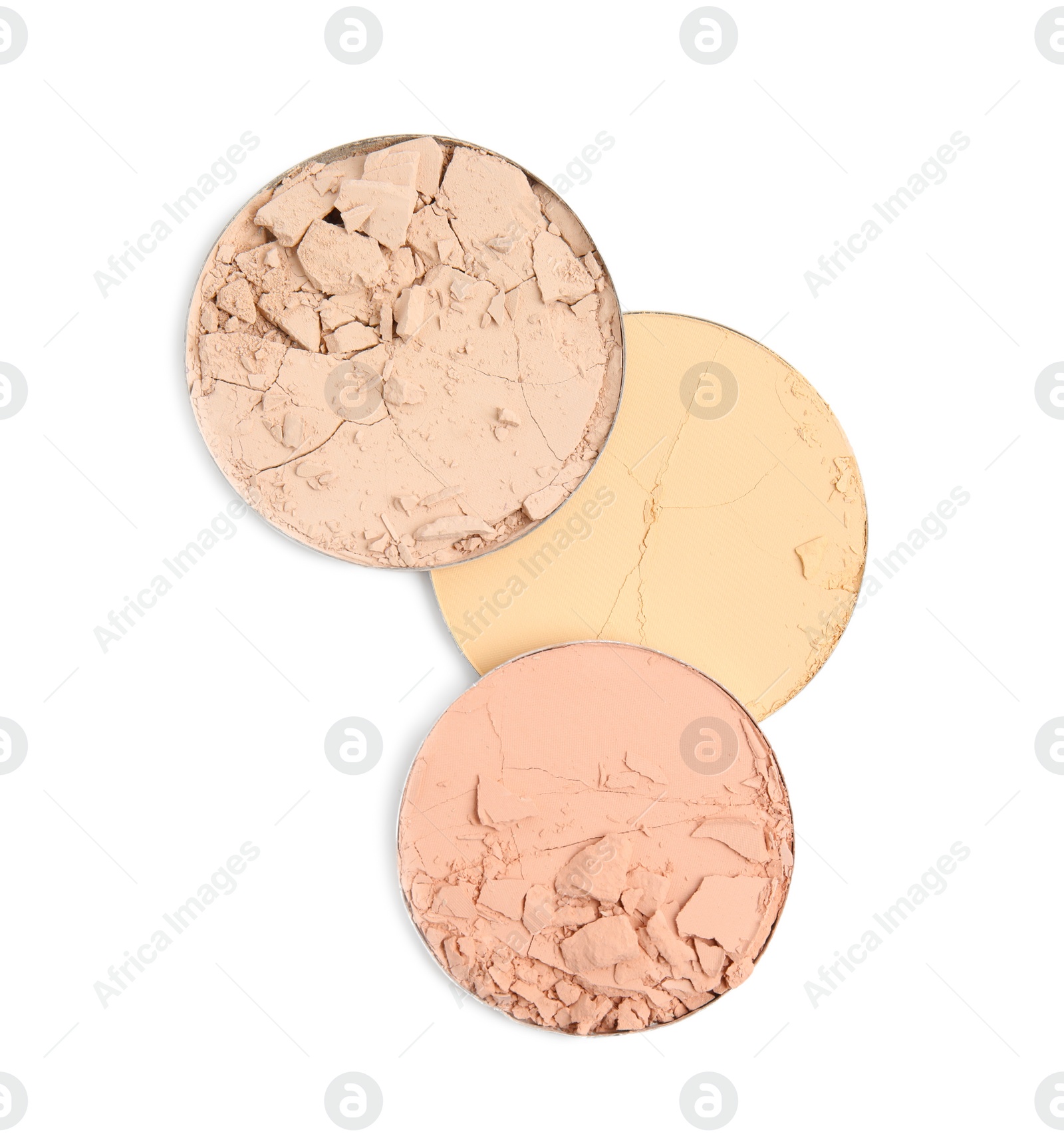 Photo of Different broken face powders on white background, top view