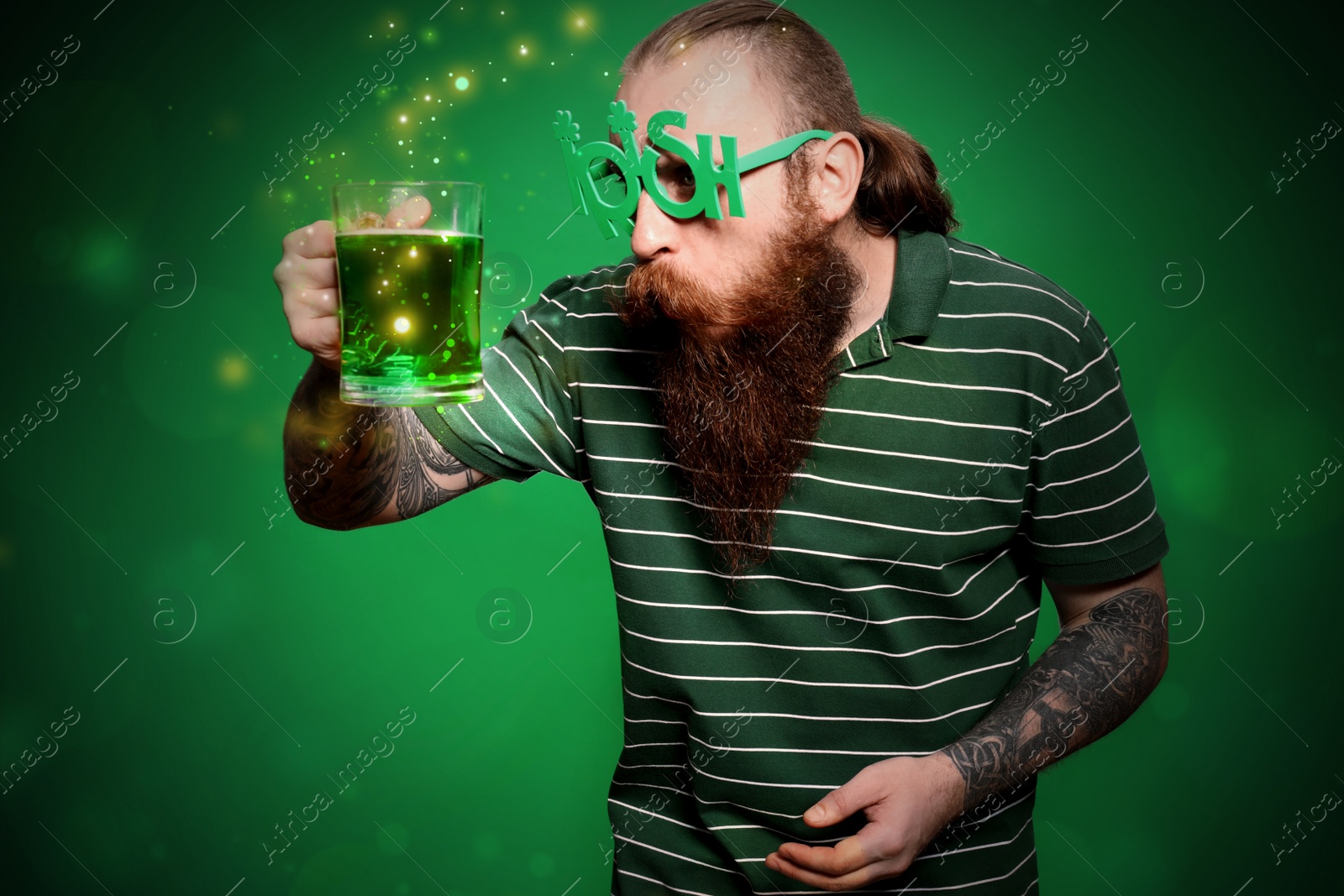 Image of Man with beer on green background. St. Patrick's Day celebration