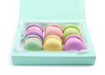 Photo of Many delicious colorful macarons in box on white background