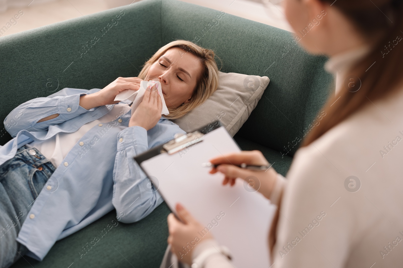 Photo of Professional psychotherapist working with patient in office