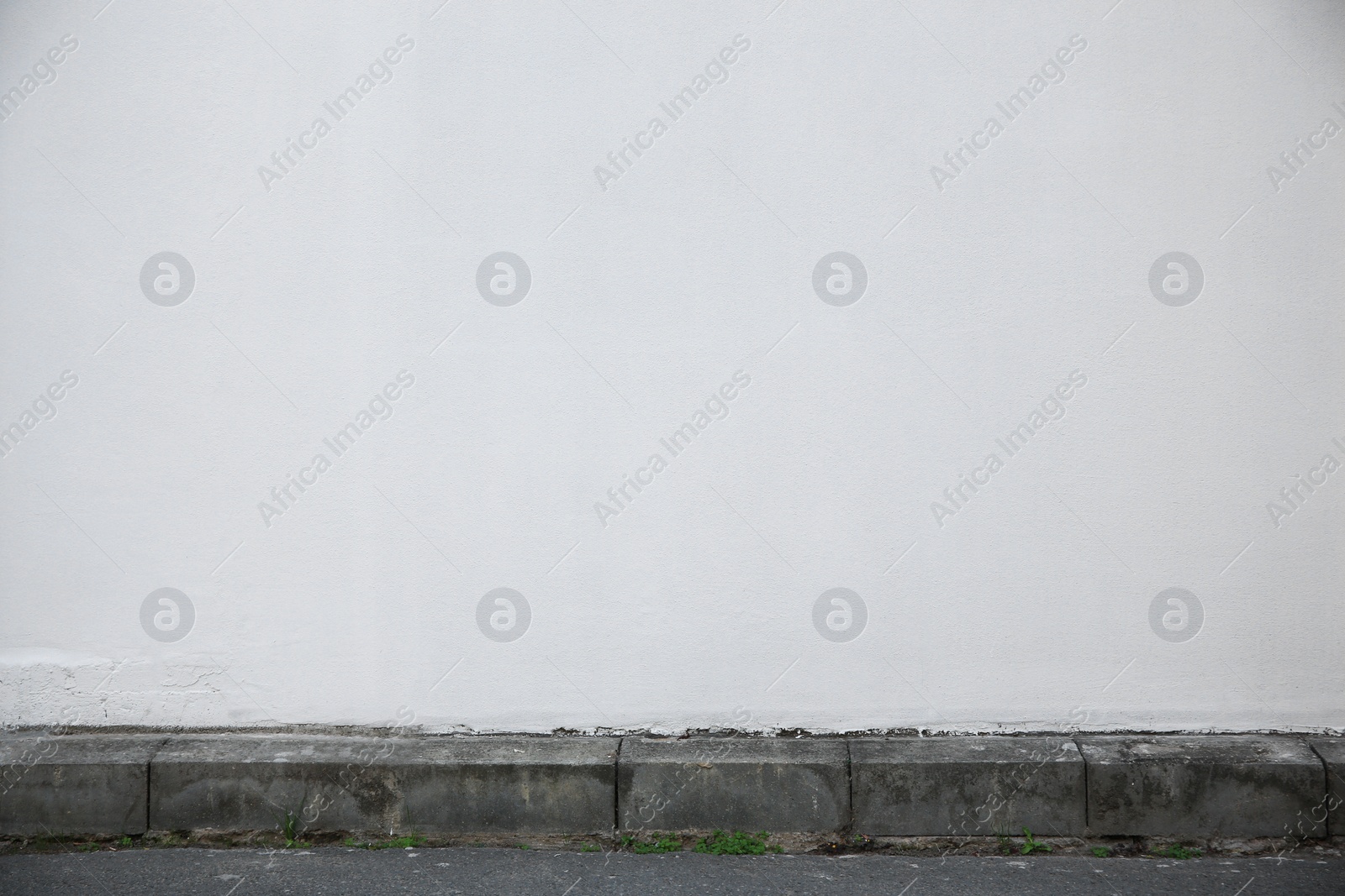 Photo of White stone wall of building outdoors. Exterior design