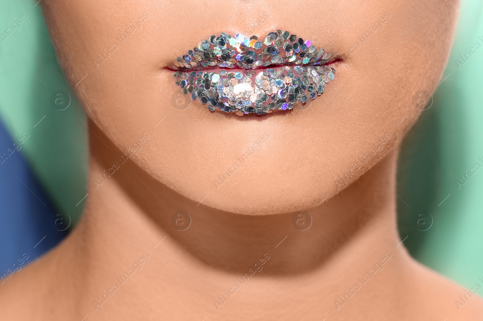 Photo of Beautiful young model with extravagant lips makeup on color background