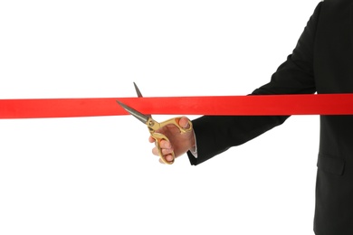 Man in office suit cutting red ribbon isolated on white, closeup